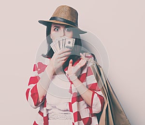 Portrait of the young woman with shopping bags and money