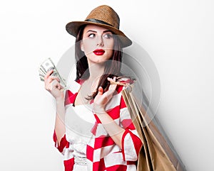 Portrait of the young woman with shopping bags and money
