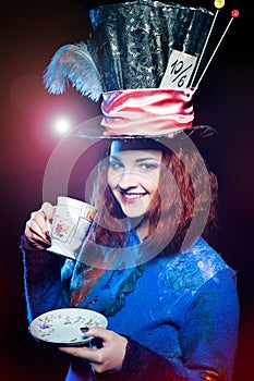 Portrait of young woman in the similitude of the Hatter drinking