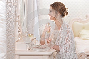 Portrait of young woman sitting at dressing table