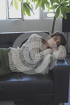 Portrait of a young woman sleeping on a sofa