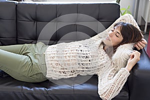 Portrait of a young woman sleeping on a sofa