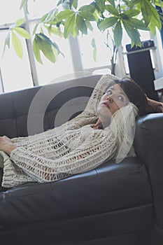 Portrait of a young woman sleeping on a sofa