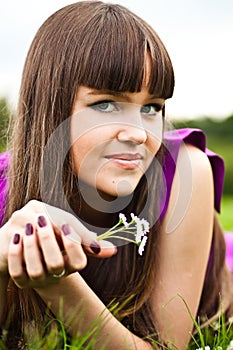 Portrait of young woman with small bouquet