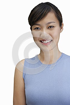 Portrait of young woman smiling against white background