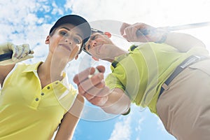 Portrait of a young woman smiling during professional golf game