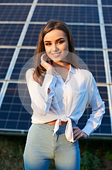 Portrait of a young woman by a solar panel