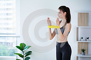 Portrait of young woman in sportswear, doing fitness exercise.