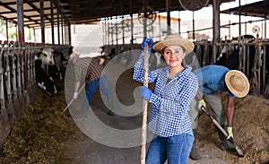 Portrait of a young woman standing on a cattle farm