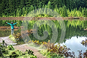 Portrait of young woman standing next to the volcanic lake.