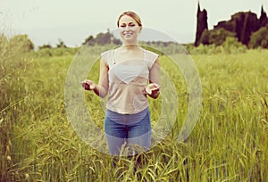 Portrait of young woman standing in wheat field