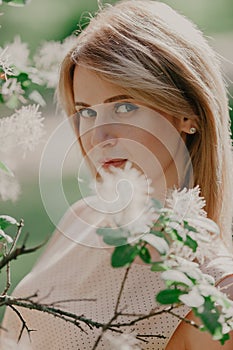 Portrait of young woman in summer garden