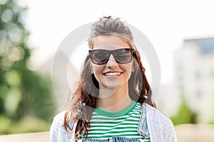 Portrait of young woman in sunglasses outdoors