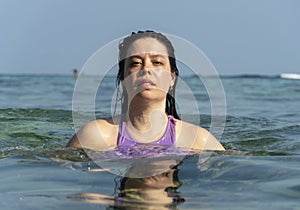 Portrait of young woman swimming in the ocean