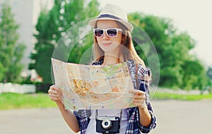 Portrait young woman tourist sightseeing city with paper map