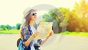 Portrait of young woman tourist sightseeing city with paper map