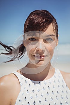 Portrait of young woman with tousled hair at beach