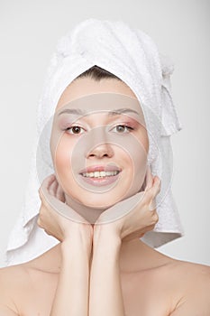 Portrait of a young woman with a towel around her head. Face care concept