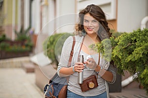 Portrait of young woman travelling in european city.