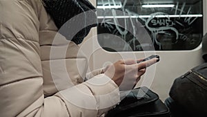 Portrait of a Young Woman Typing Message On Mobile Phone In Subway Train, Blonde Woman With Smartphone