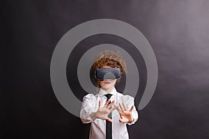 Portrait of a young woman with virtual reality goggles in a studio.