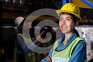 Portrait of young woman warehouse worker smiling in the storehouse