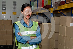 Portrait of young woman warehouse worker smiling in the storehouse