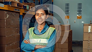 Portrait of young woman warehouse worker smiling in the storehouse