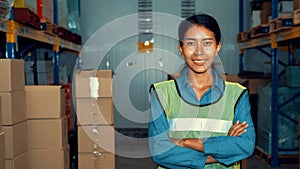 Portrait of young woman warehouse worker smiling in the storehouse