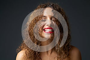 Portrait of a young woman with water dripping from face