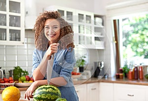 Young woman with watermelon and a knife stabbed in photo