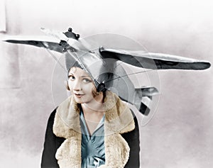 Portrait of a young woman wearing an airplane shaped cap photo