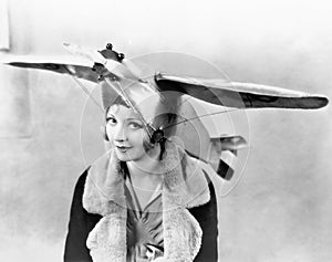 Portrait of a young woman wearing an airplane shaped cap