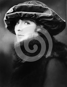 Portrait of a young woman wearing a hat and a fur stole