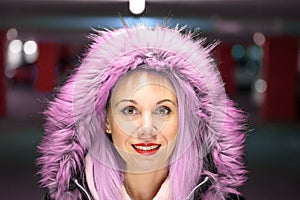 Portrait of young woman wearing pink fur coat