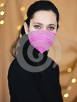 Portrait of young woman wearing protective mask KN95 FFP2