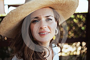 Portrait of young woman in white shirt with hat