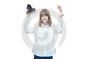 Portrait of a young woman in a white shirt holding a camera and Russian money rubles in her hand. The concept of a