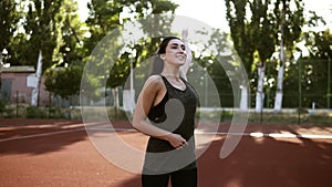 Portrait of young woman, who is warming up her hand muscules before training, slow motion. Beautiful brunette lady in