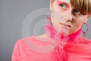 Portrait of young woman wich pink plume