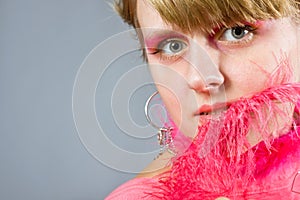 Portrait of young woman wich pink plume