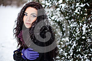 Portrait of young woman in winter forest photo