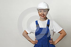 Portrait of young woman worker standing on white background