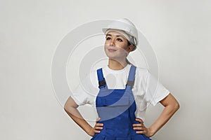 Portrait of young woman worker standing on white background