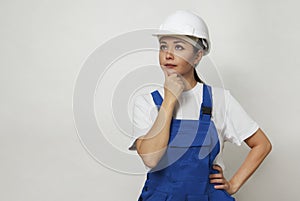 Portrait of young woman worker standing on white background