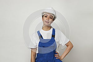 Portrait of young woman worker standing on white background