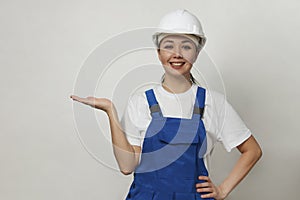 Portrait of young woman worker standing on white background