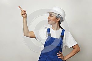Portrait of young woman worker standing on white background