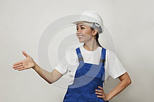 Portrait of young woman worker standing on white background