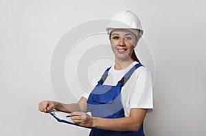 Portrait of young woman worker standing on white background